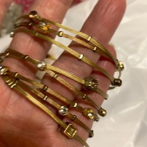 called Whisper Bracelets. are gold color with white stones. Old & pretty